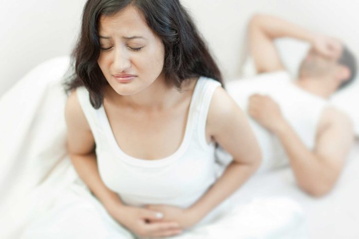 woman in pain holding her abdomen