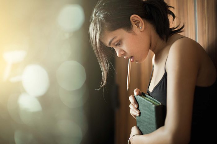 Woman holding a book and looking down