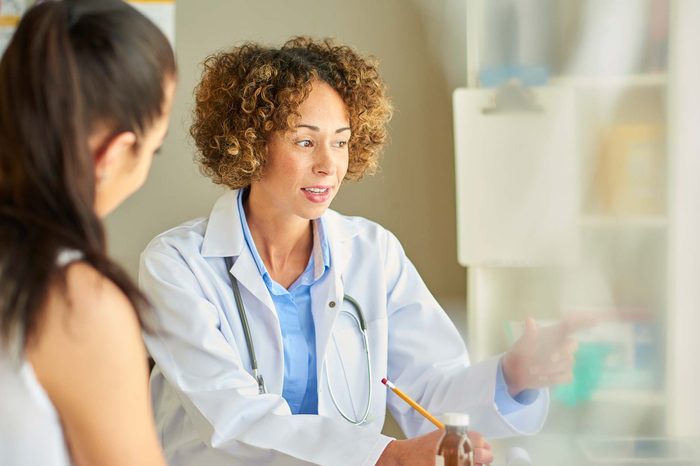 Woman doctor speaking to a woman patient in her office.