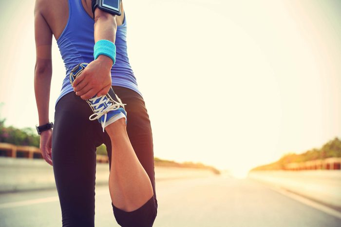 woman stretching before run