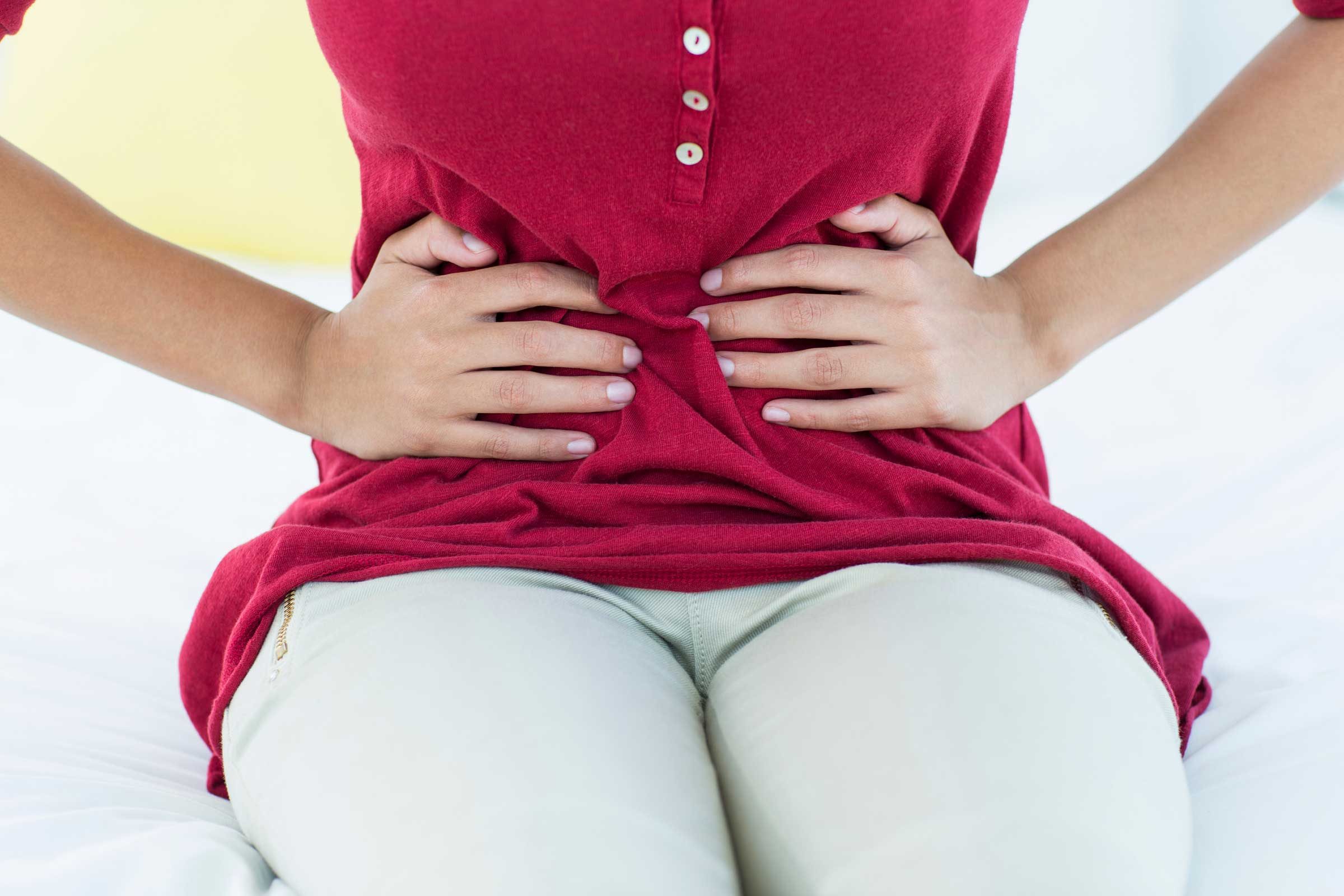 woman with her hands on her abdomen