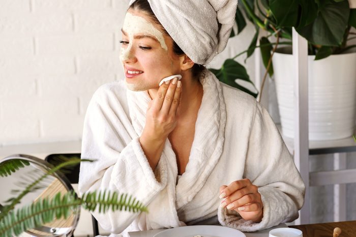 woman removing face mask