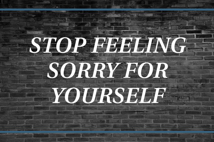 Brick wall background that says: Stop feeling sorry for yourself.