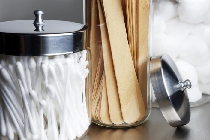 Jar of cotton swabs and throat sticks at a doctor's office.