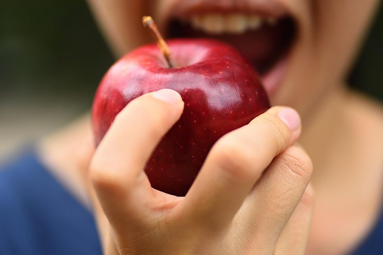 woman biting apple