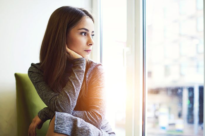 woman contemplating window