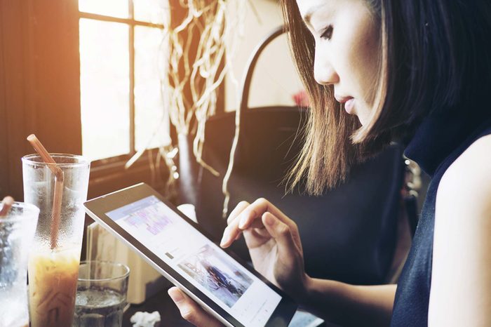 Woman in coffee shop on iPad