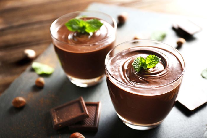 Two bowls of chocolate pudding on table