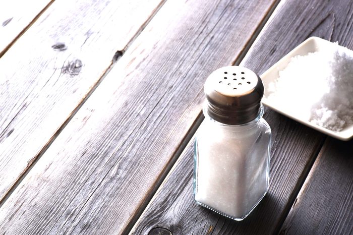 Salt shaker on wooden table