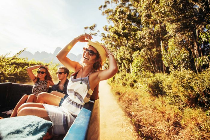 happy woman in sun with friends