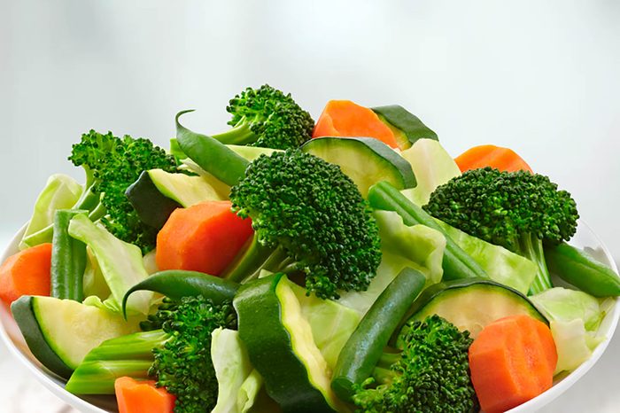 chopped broccoli, carrots, green beans, and zucchini in a white bowl