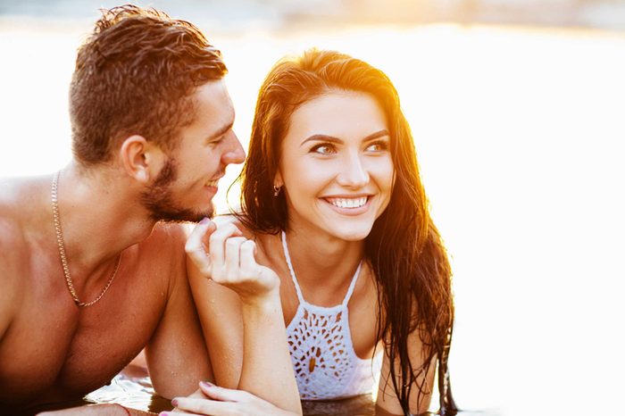 man and a woman resting on their elbows in the sun