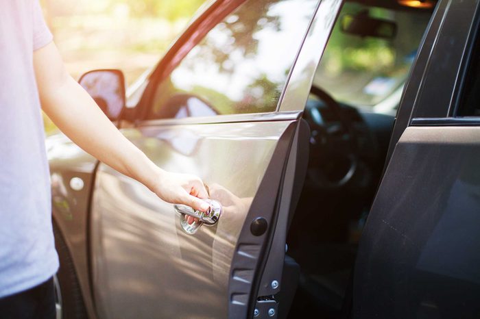 a person opening a car door