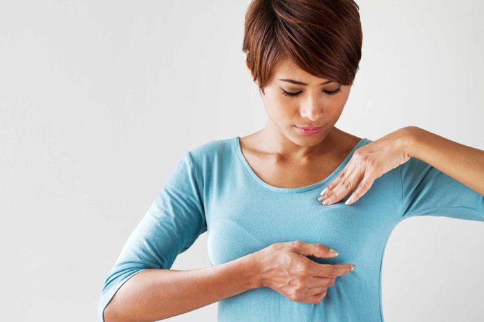 women looking at breast in shirt