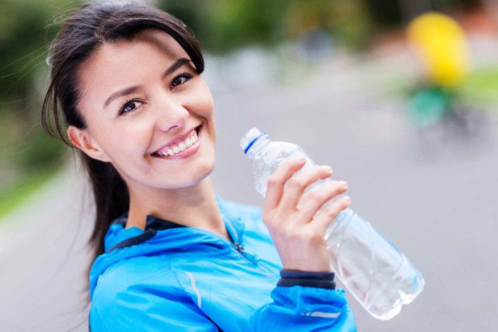 woman drinking a bottle of water