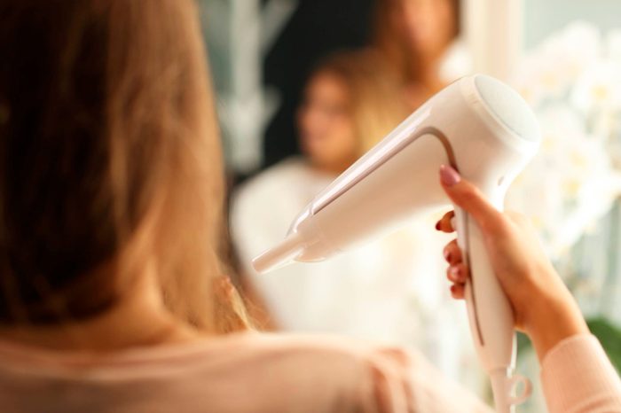 woman blowdrying hair