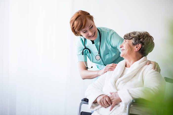 nurse talking with woman in wheelchair