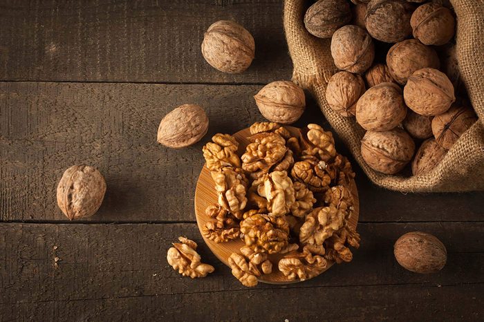 Walnuts shelled and unshelled on a wooden table