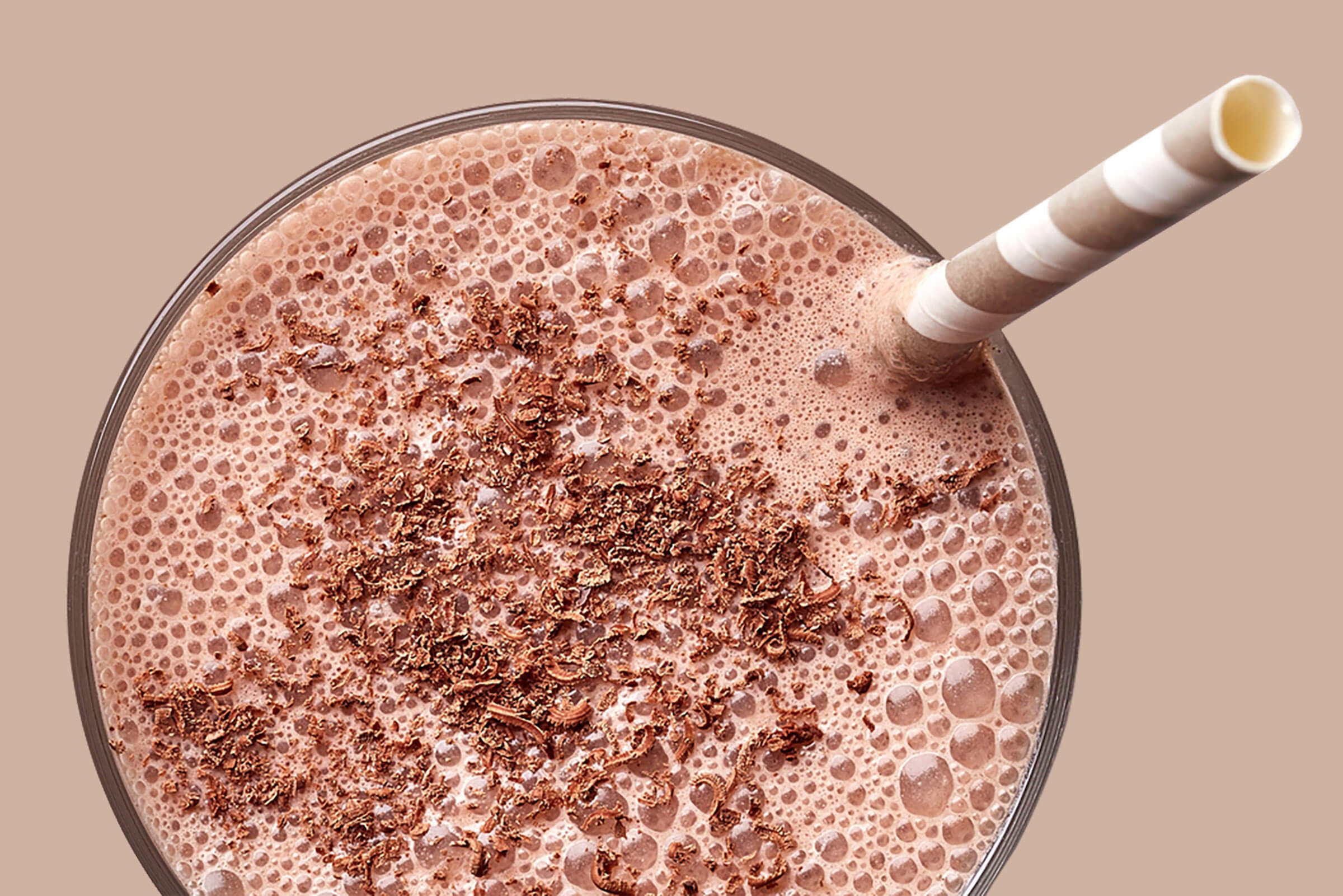 close-up of chocolate shake with a striped straw