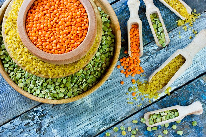 bowls of red, yellow, and green lentils with scoops