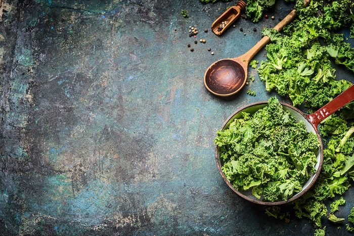 Kale in a bowl and scattered on a slate table