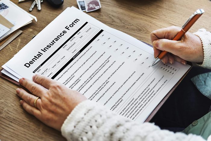 person filling out a Dental insurance form