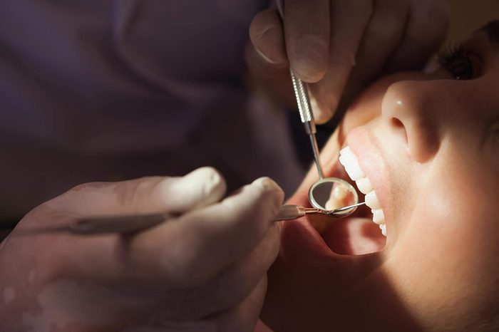 Dentist examining patient's mouth