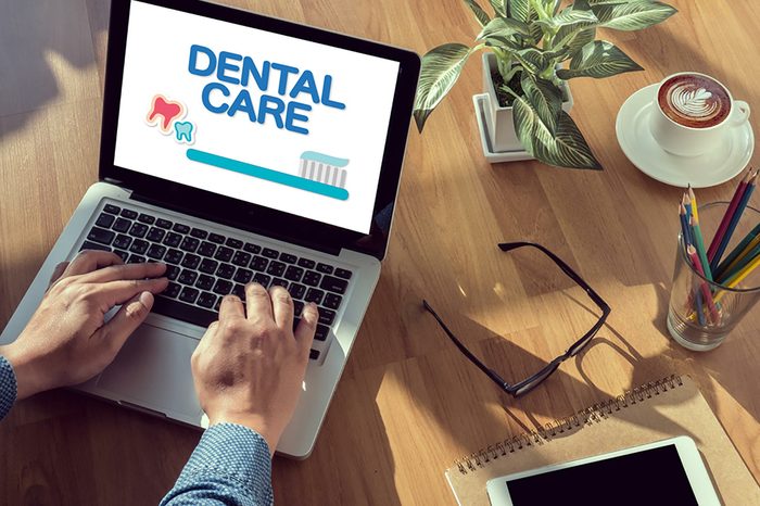 person checking out dental care on a laptop computer