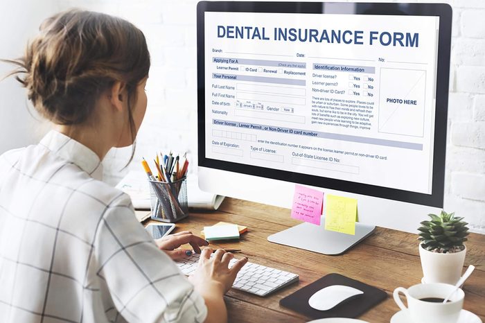 person checking dental form on computer