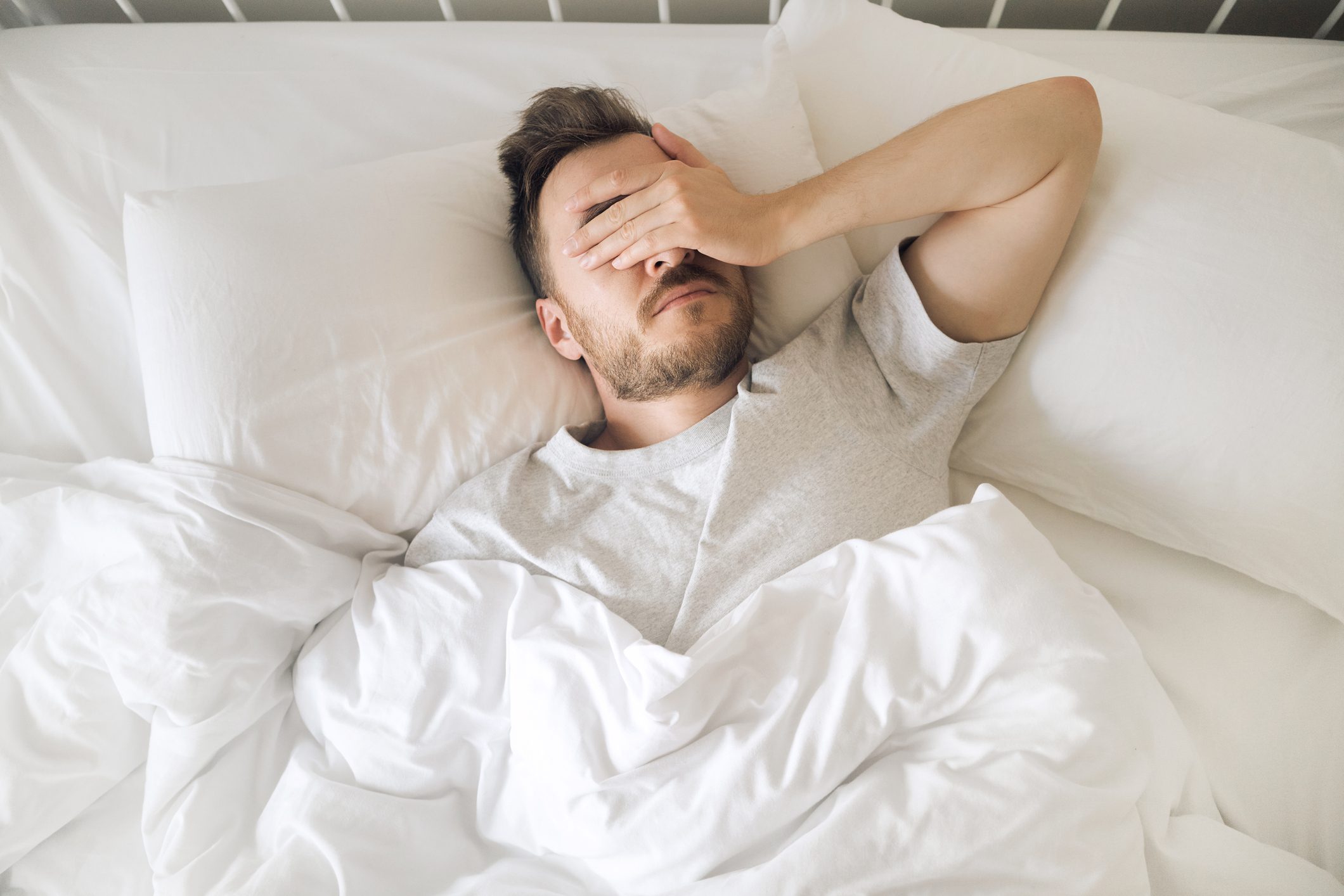 man suffering from insomnia overhead shot