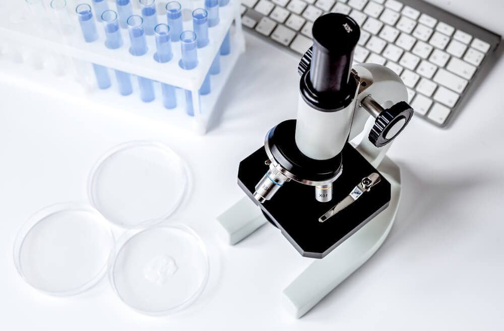 Microscope in the laboratory with test tubes