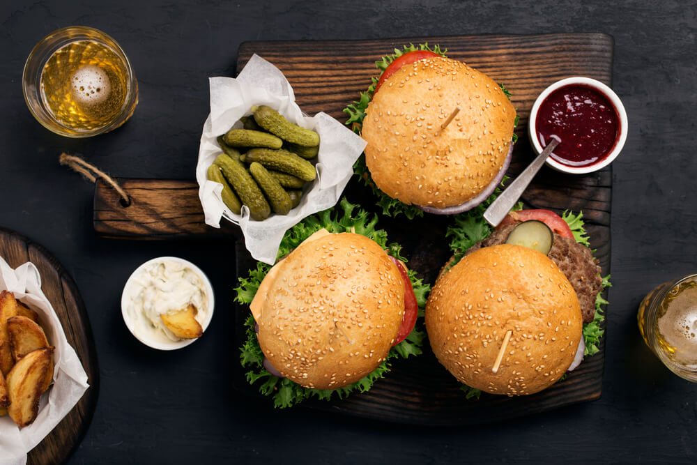 hamburgers, pickles, fries, and condiments