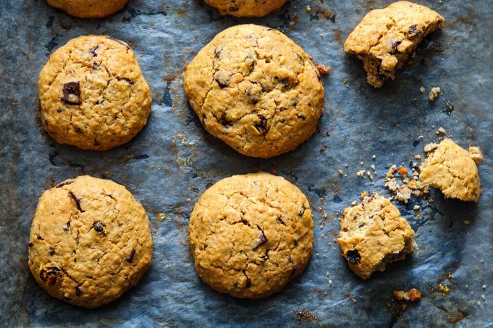 Freshly baked oat raisin cookies on baking paper