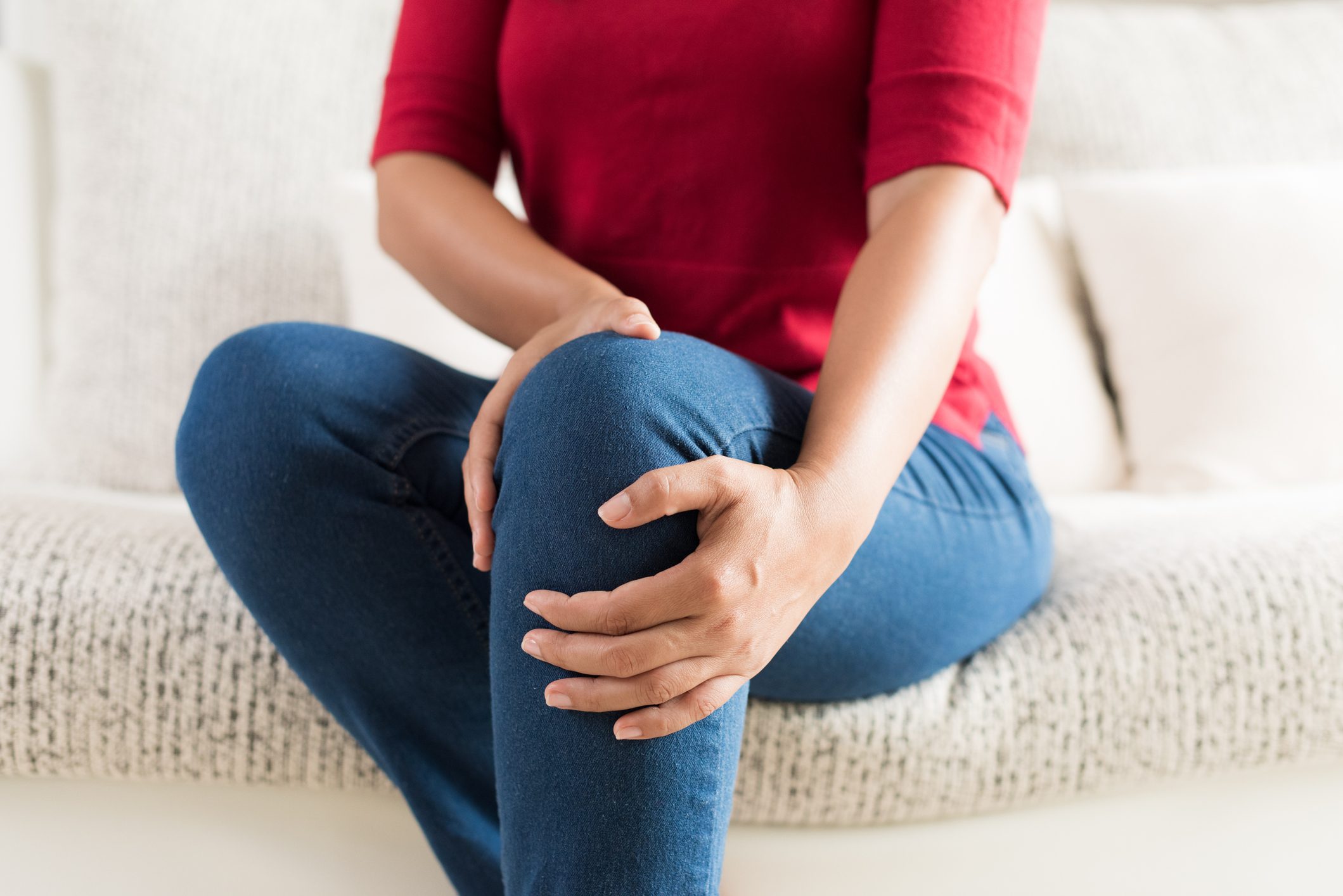 close up of woman holding knee area