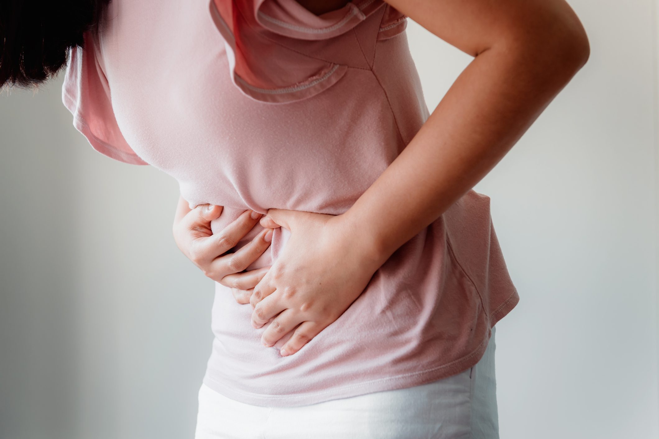 cropped shot of woman holding stomach from pain