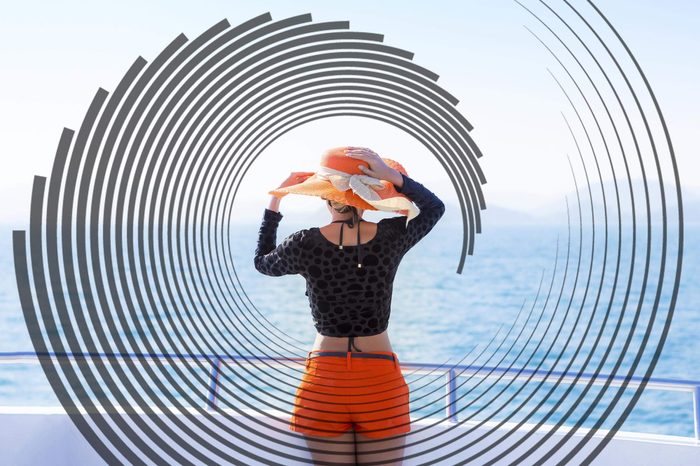 woman on the deck of a boat gazing out at the water