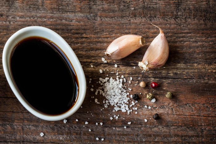 balsamic vinegar in a bowl with salt, peppercorns, and garlic