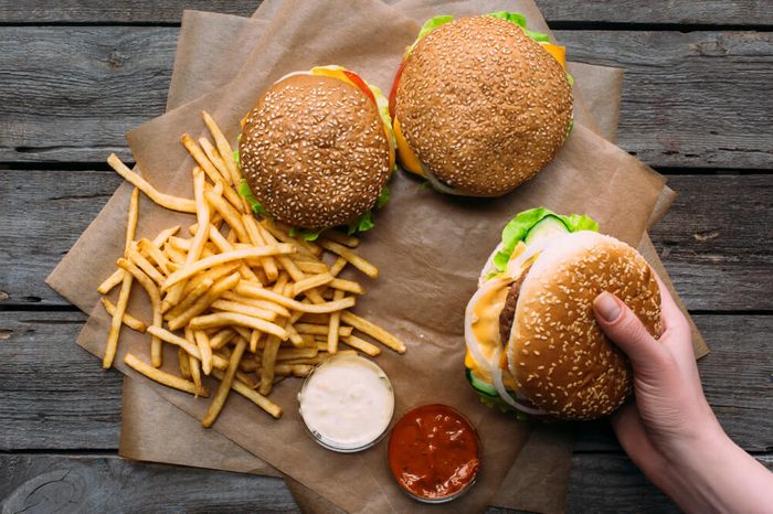 Hamburgers with french fries and sauces.