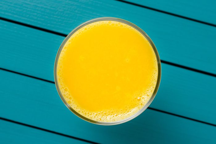 Fresh orange juice on wooden table