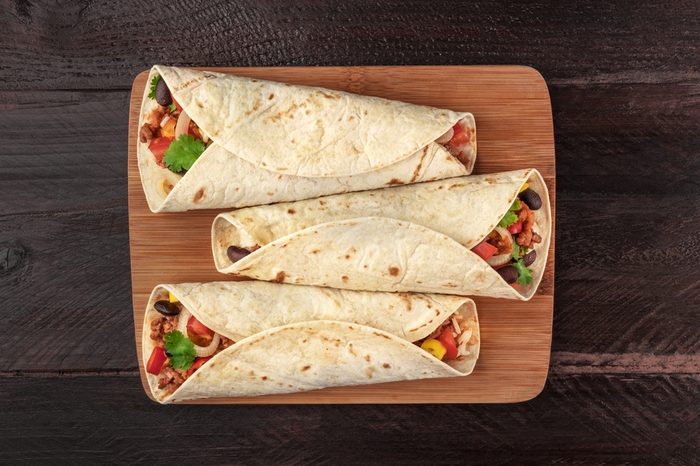 Mexican burritos on a wooden slab