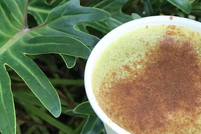 match in a cup next to a plant