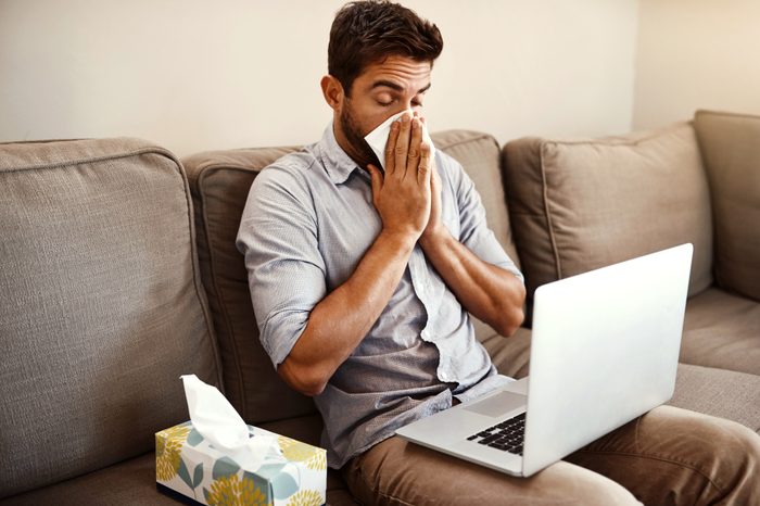 man with allergies blowing his nose