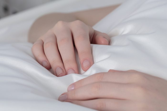 Close-up of sick girl's hands with peripheral venous line