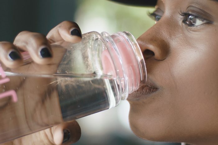 Woman drinking water from a plastic bottle