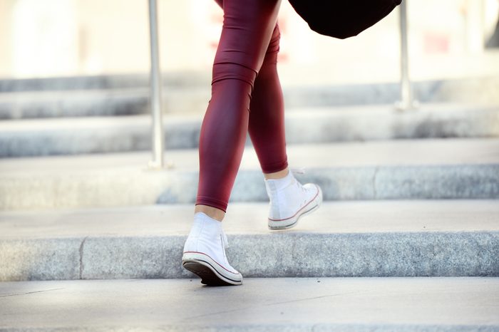 Young adult woman walking up the stairs