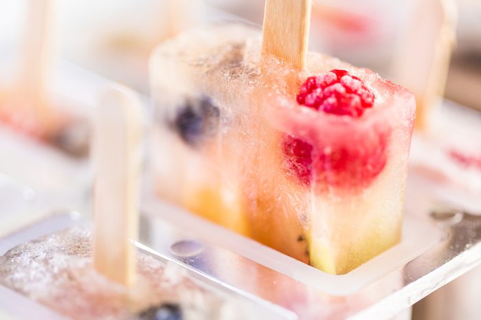 Homemade fresh fruit popsicles with raspberries and blueberries