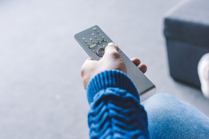 Man holding tv remote