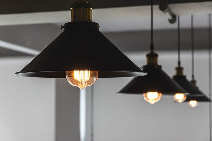 A group of hanging pendant lights showing low light