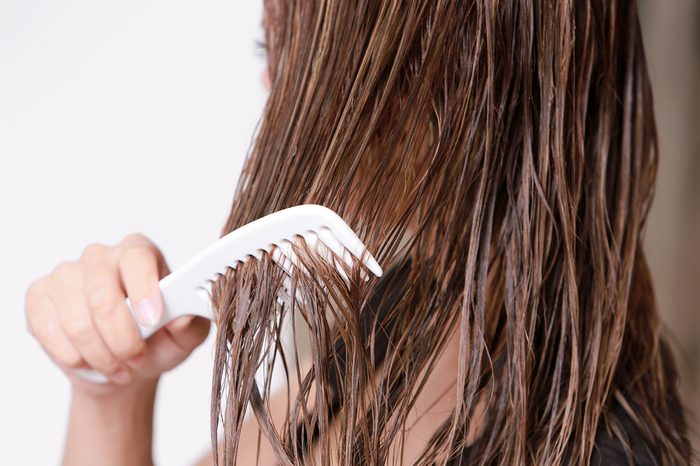 Woman with a comb in her hand on dressing room.