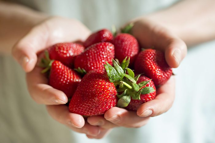 Man hands holding fresh strawberries